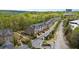 Aerial view of townhomes showcasing brick facades, attached garages, and landscaped lawns in a desirable community at 126 Abbington River Ln, Atlanta, GA 30339