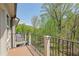 Enjoy the beautiful wooded view from this home's private balcony with a sturdy iron railing and wood floor at 126 Abbington River Ln, Atlanta, GA 30339