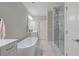 Relax in this bathroom, featuring a soaking tub, glass shower, and double vanity at 126 Abbington River Ln, Atlanta, GA 30339