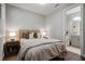 Cozy bedroom with gray walls, hardwood floors, an ensuite bathroom and bedside lamps at 126 Abbington River Ln, Atlanta, GA 30339