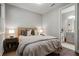Cozy bedroom with hardwood floors, soft lighting, and an ensuite bathroom at 126 Abbington River Ln, Atlanta, GA 30339