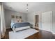 The bedroom features a large bed and hardwood flooring adjacent to an ensuite bathroom at 126 Abbington River Ln, Atlanta, GA 30339