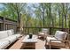 Relaxing outdoor deck with comfortable seating surrounded by mature trees at 126 Abbington River Ln, Atlanta, GA 30339