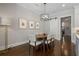 Dining area with modern chandelier lighting and a view of the pantry barn door at 126 Abbington River Ln, Atlanta, GA 30339