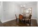 Cozy dining room showcasing hardwood floors, a chandelier, and a classic mirror at 126 Abbington River Ln, Atlanta, GA 30339