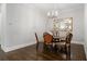 Elegant dining room with dark hardwood floors and a stylish chandelier and large mirror at 126 Abbington River Ln, Atlanta, GA 30339
