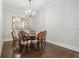 Elegant dining room featuring a chandelier, hardwood floors, and neutral paint colors at 126 Abbington River Ln, Atlanta, GA 30339