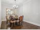Traditional dining room with wood floors, classic chandelier and wall mirror at 126 Abbington River Ln, Atlanta, GA 30339