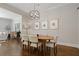 Cozy dining room area with a round wooden table, comfortable seating, and stylish light fixture at 126 Abbington River Ln, Atlanta, GA 30339