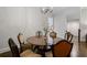 Well-lit dining area with a round wooden table, chandelier, and stairs in view at 126 Abbington River Ln, Atlanta, GA 30339
