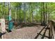 Wooded dog park area featuring a dog waste station, benches, and a fenced in area at 126 Abbington River Ln, Atlanta, GA 30339