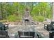 Charming stone fire pit with seating offering a cozy outdoor gathering space at 126 Abbington River Ln, Atlanta, GA 30339