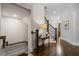 Hallway with hardwood floors and staircase to lower and upper levels at 126 Abbington River Ln, Atlanta, GA 30339