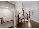 Welcoming foyer with a staircase, hardwood floors, and a decorative console table at 126 Abbington River Ln, Atlanta, GA 30339