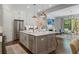 Modern kitchen with stainless steel appliances, an island, and an open view to the living area at 126 Abbington River Ln, Atlanta, GA 30339