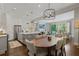 Open concept kitchen and dining area with dark hardwood floors, stainless steel appliances, and modern lighting at 126 Abbington River Ln, Atlanta, GA 30339