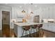 Bright, modern kitchen with an island, stainless steel appliances, and stylish pendant lighting at 126 Abbington River Ln, Atlanta, GA 30339