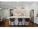 Well-lit kitchen with a large island featuring seating, stainless steel appliances, and adjacent dining area at 126 Abbington River Ln, Atlanta, GA 30339