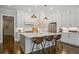 Bright kitchen features stainless steel appliances, a large island with seating, and white cabinetry at 126 Abbington River Ln, Atlanta, GA 30339