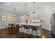 Bright, white kitchen featuring a large center island, modern pendant lighting, and stainless steel appliances at 126 Abbington River Ln, Atlanta, GA 30339