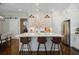 Modern kitchen features an island with barstool seating, stainless steel appliances, and pendant lighting at 126 Abbington River Ln, Atlanta, GA 30339