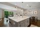 Open concept kitchen with large island, stainless steel appliances, and adjacent living and dining spaces at 126 Abbington River Ln, Atlanta, GA 30339