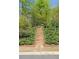 Stone steps leading up a lush green hillside with beautiful landscaping at 126 Abbington River Ln, Atlanta, GA 30339