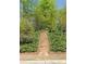Beautifully landscaped walkway with stone steps leading through lush greenery at 126 Abbington River Ln, Atlanta, GA 30339