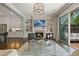 Open-concept living space featuring fireplace, balcony, and view to the kitchen at 126 Abbington River Ln, Atlanta, GA 30339