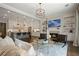 Open-concept living area with a cozy fireplace and a view of the modern kitchen at 126 Abbington River Ln, Atlanta, GA 30339