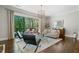 Bright living room featuring a balcony, comfortable seating, and a stylish rug at 126 Abbington River Ln, Atlanta, GA 30339