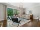 Bright living room with hardwood floors, large windows to the deck, and comfortable seating at 126 Abbington River Ln, Atlanta, GA 30339