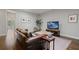 Cozy living room featuring a leather sofa, television, and a decorative rug at 126 Abbington River Ln, Atlanta, GA 30339