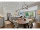 Open-concept living area featuring a dining area, kitchen island, and comfortable seating at 126 Abbington River Ln, Atlanta, GA 30339