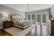 Bright main bedroom with large windows, hardwood floors, and elegant furnishings for a relaxing retreat at 126 Abbington River Ln, Atlanta, GA 30339