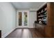 Office featuring a walkout to a deck with wood floors, and a built-in bookcase at 126 Abbington River Ln, Atlanta, GA 30339
