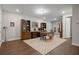 Spacious office with wood floors, built-in shelving, a patterned rug, and a walkout to a patio at 126 Abbington River Ln, Atlanta, GA 30339