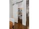 Pantry with a white sliding barn door, offering ample storage space at 126 Abbington River Ln, Atlanta, GA 30339