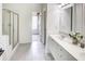 Bright bathroom with dual sinks, white cabinets, and a glass-enclosed shower, creating a clean and functional space at 2175 Eagle Trce, Cumming, GA 30040