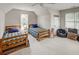 Spacious bedroom with twin beds, carpeted floor, sloped ceilings, and a window for natural light, perfect for children at 2175 Eagle Trce, Cumming, GA 30040