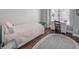 Comfortable bedroom with hardwood floors, a twin bed, and a desk, offering a cozy and inviting atmosphere at 2175 Eagle Trce, Cumming, GA 30040