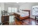 Serene main bedroom featuring a large bed, hardwood floors, natural light, and elegant furnishings at 2175 Eagle Trce, Cumming, GA 30040
