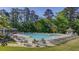 Large community pool surrounded by seating and lush trees, ideal for summer relaxation at 2175 Eagle Trce, Cumming, GA 30040