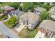 Beautiful aerial view of the brick and siding home in a neighborhood with a well-manicured lawn and mature trees at 2311 Norbury Se Cv, Smyrna, GA 30080