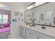 Bright bathroom featuring a double sink vanity with a large mirror and stylish decor, adjoining a colorful bedroom at 2311 Norbury Se Cv, Smyrna, GA 30080