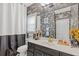 Stylish bathroom showcasing patterned wallpaper, modern fixtures, and a framed mirror above the vanity at 2311 Norbury Se Cv, Smyrna, GA 30080