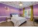 Cozy bedroom with lilac walls, floral ceiling, and lots of natural light creating a peaceful retreat at 2311 Norbury Se Cv, Smyrna, GA 30080