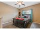 Cozy bedroom with a ceiling fan, a comfortable bed, and a window with pleasant natural light at 2311 Norbury Se Cv, Smyrna, GA 30080