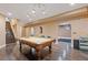 A billiards room with hardwood floors, a pool table, staircase and open floor plan at 2311 Norbury Se Cv, Smyrna, GA 30080