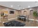 Dining area with dark hardwood floors, a modern table, and arched entryways to other living spaces at 2311 Norbury Se Cv, Smyrna, GA 30080
